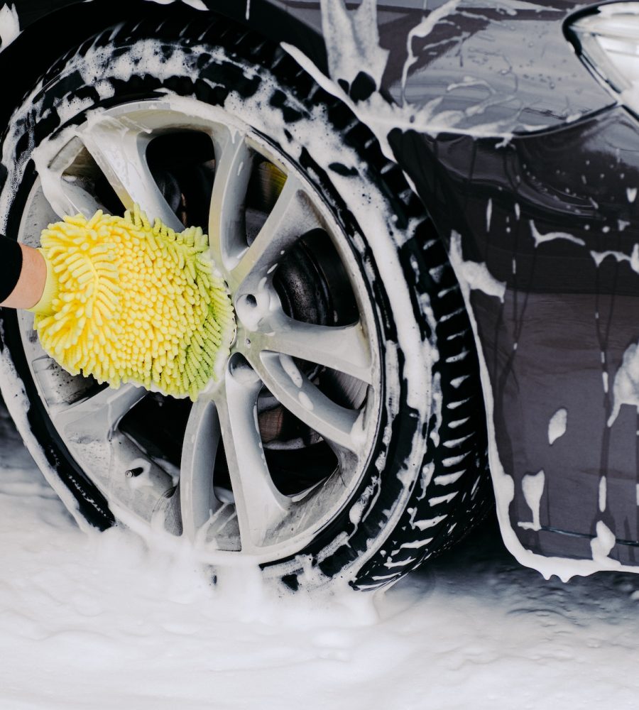 workers-hand-with-yellow-sponge-washing-car-wheels-with-detergent-for-cleaning-vehicles.jpg